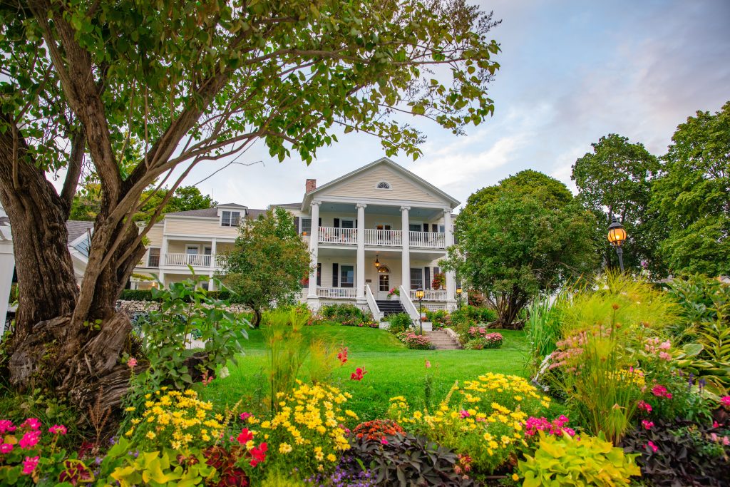 Flowers bloom around the lawn in front of the historic Harbour View Inn on Mackinac Island