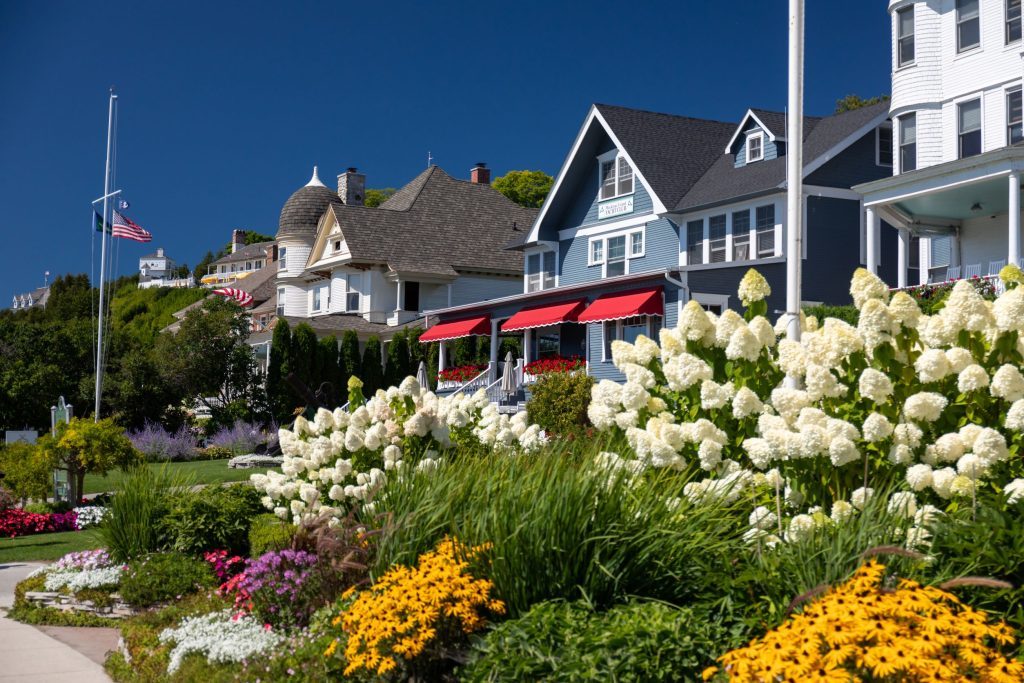 Colorful flowers beautify the front landscaping of a Mackinac Island cottage