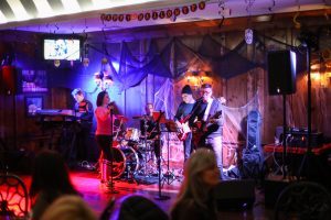 A band plays live music as patrons dance in a bar on Mackinac Island during Halloween Weekend