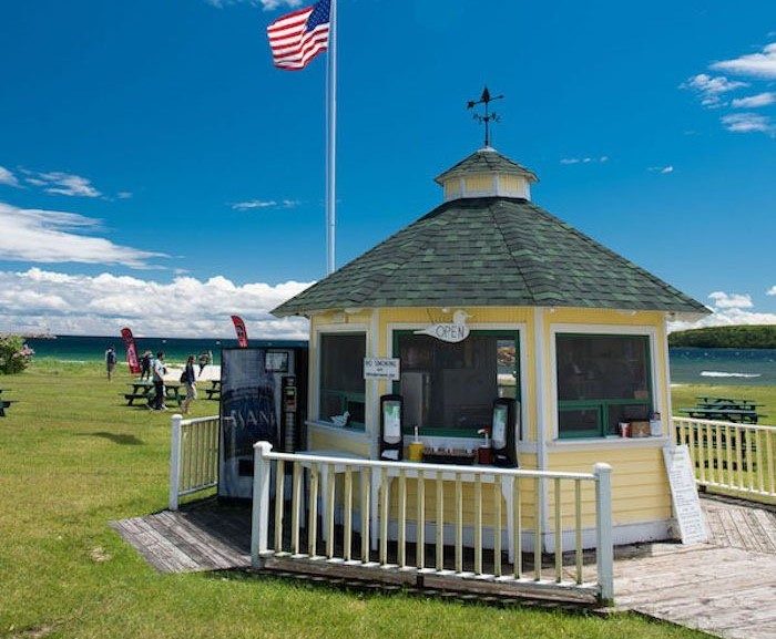 The hexagonal, yellow Doghouse building serves hot dogs on Mackinac Island’s Windermere Point