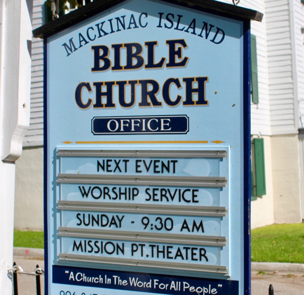 A changeable sign showing worship service times at Mackinac Island Bible Church