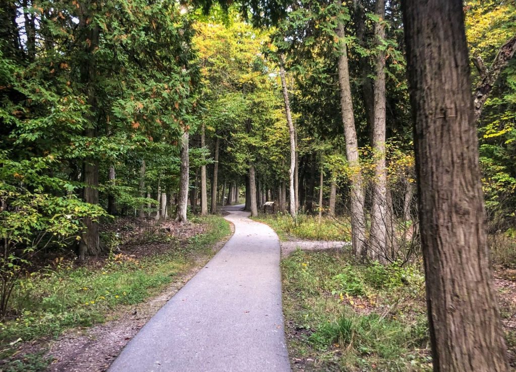 A paved path through Mackinac Island State Park on the Mackinac Island Botanical Trail