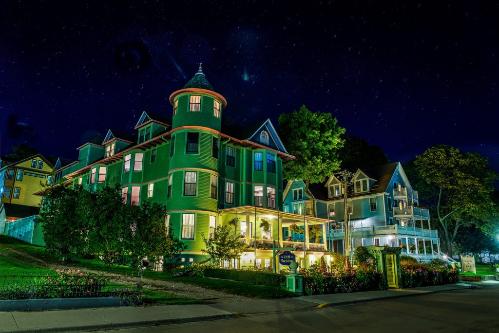 Light peeks out the windows of the distinctive Inn on Mackinac at night on Michigan’s Mackinac Island