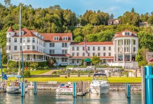 Mackinac Island’s Island House Hotel sits along Main Street east of downtown across from boats in the marina
