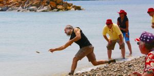 Kurt Steiner hurls a stone into the water at Mackinac Island’s Windermere Point during the annual stoneskipping contest