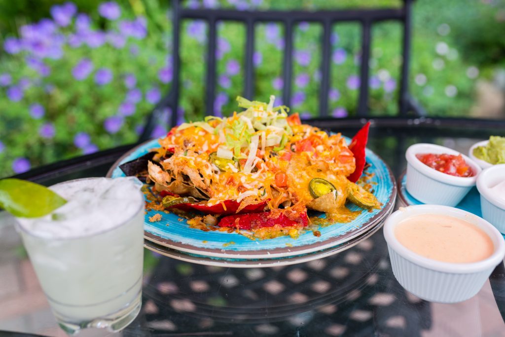 A plate of Brisket Tacos on a table in the outdoor dining space at Ice House BBQ on Mackinac Island