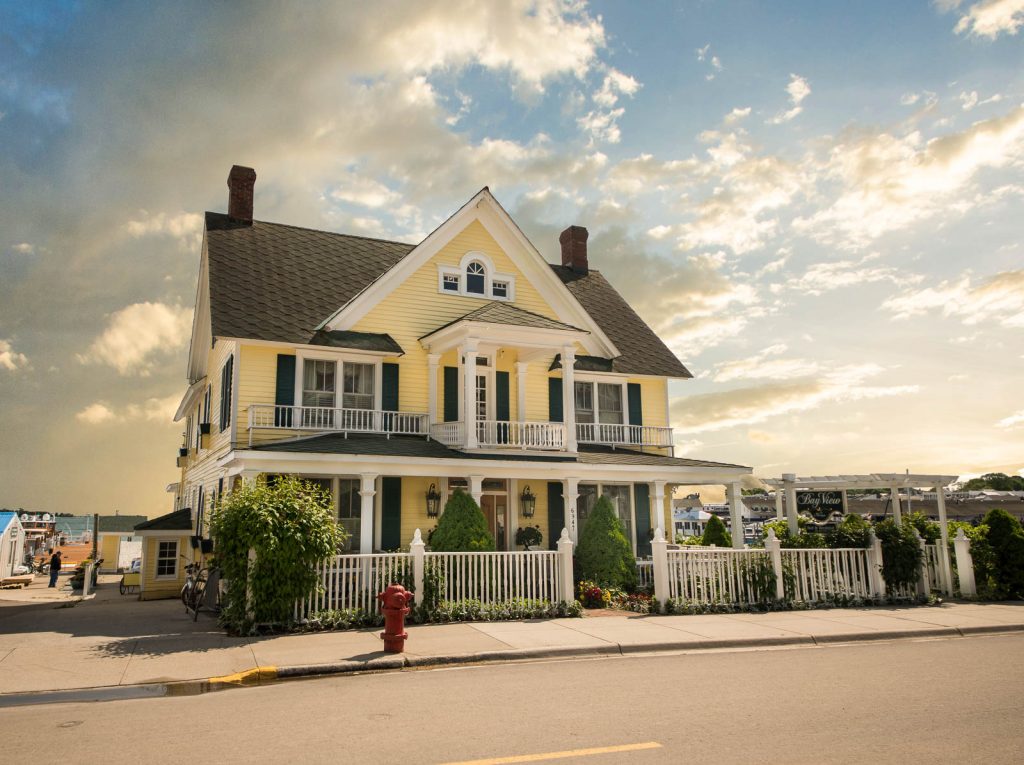 Exterior view of the Bay View B&B along the water on a beautiful sunny day on Mackinac Island