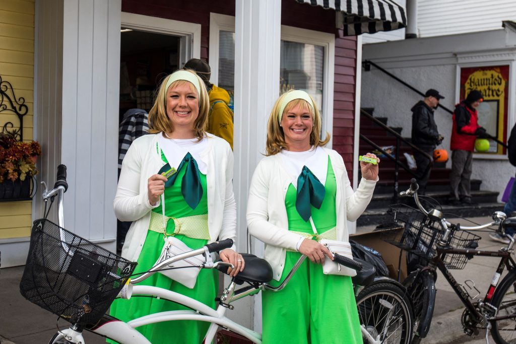 Two women dressed in Halloween costumes enjoy Mackinac Island's Halloween Weekend