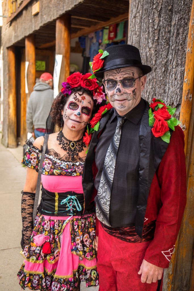 Two Mackinac Island visitors in zombie skeleton costumes during Halloween Weekend