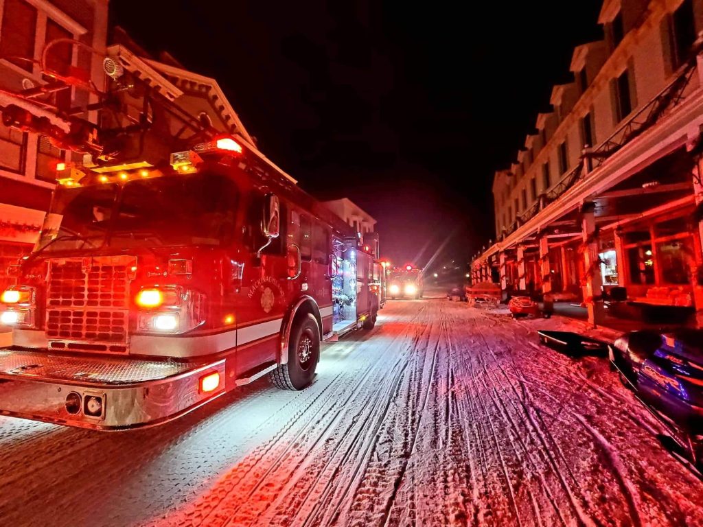 The Mackinac Island Fire Department truck responds to a late-night call on a snowy downtown street in winter