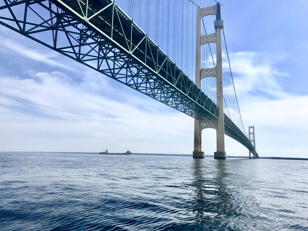 View of the Mackinac Bridge looking up from the water between Michigan’s Upper and Lower peninsulas