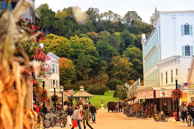 Fall scene of downtown Mackinac Island street lined with bicycles and highlighted by fall colors