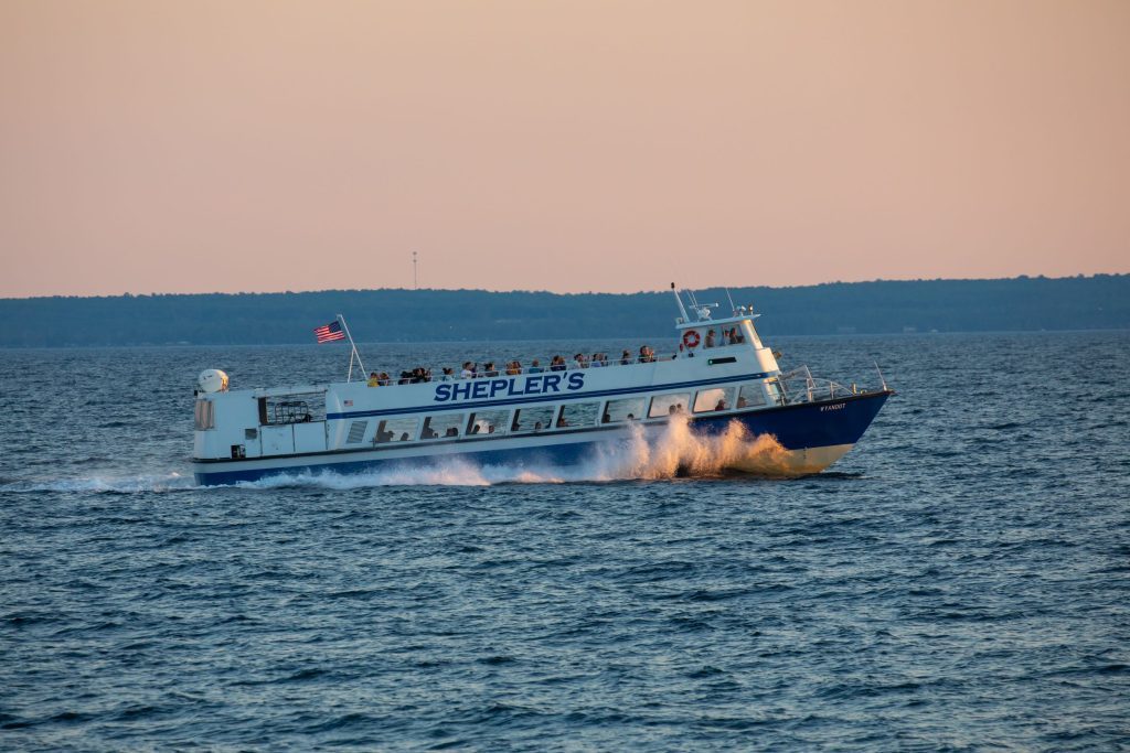 A Shepler’s Ferry boat full of passengers cruises through the water between Mackinac Island and Michigan’s mainland. 