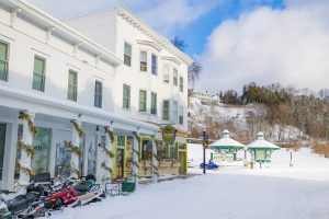 Snowmobiles line the street out front of Doud’s Market in downtown Mackinac Island on a sunny winter day