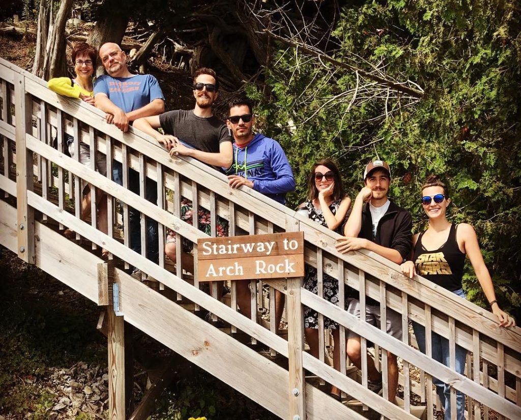 A group of adults poses for a photo on the Stairway to Arch Rock on Michigan’s Mackinac Island