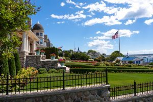 An American flag flies out front of a stately Mackinac Island cottage with gorgeous landscaping on a sunny day