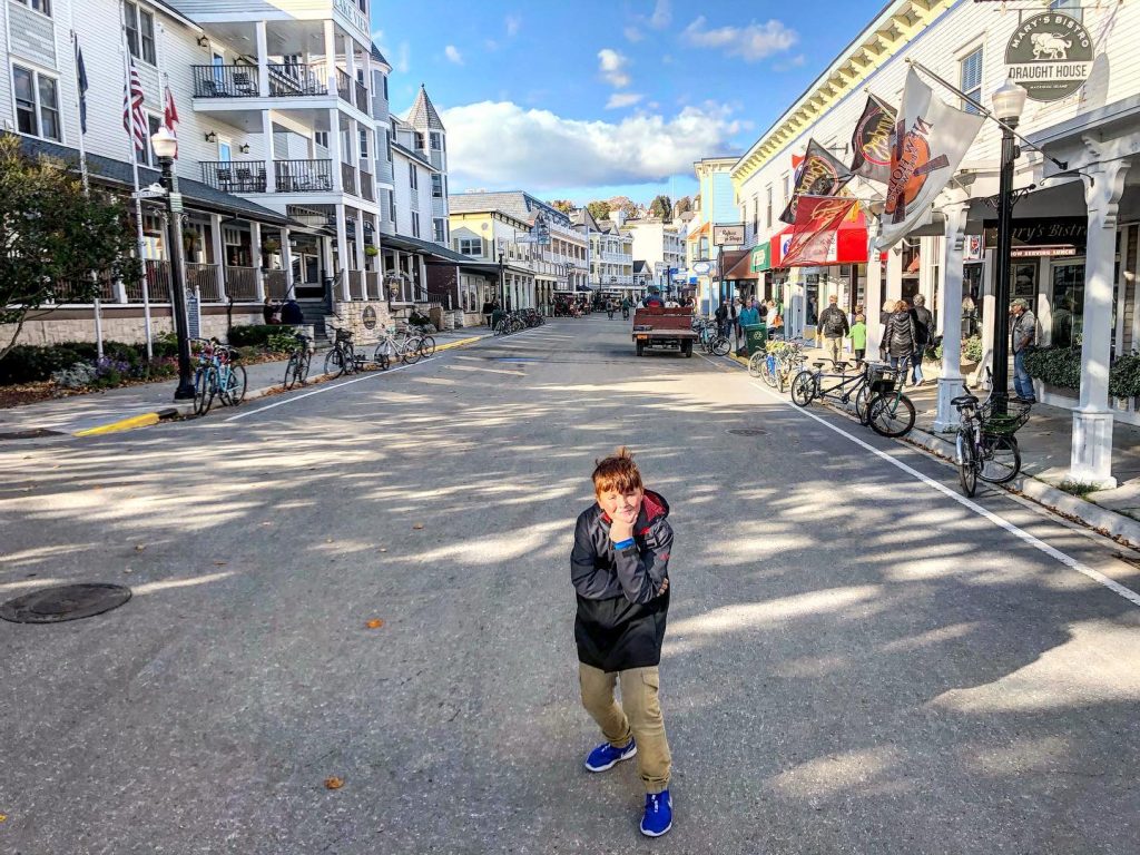 A young boy poses in the middle of Main Street on Mackinac Island