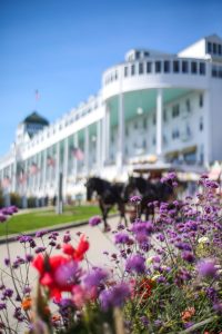 Flowers bloom outside Mackinac Island's Grand Hotel as a horse-drawn carriage goes past