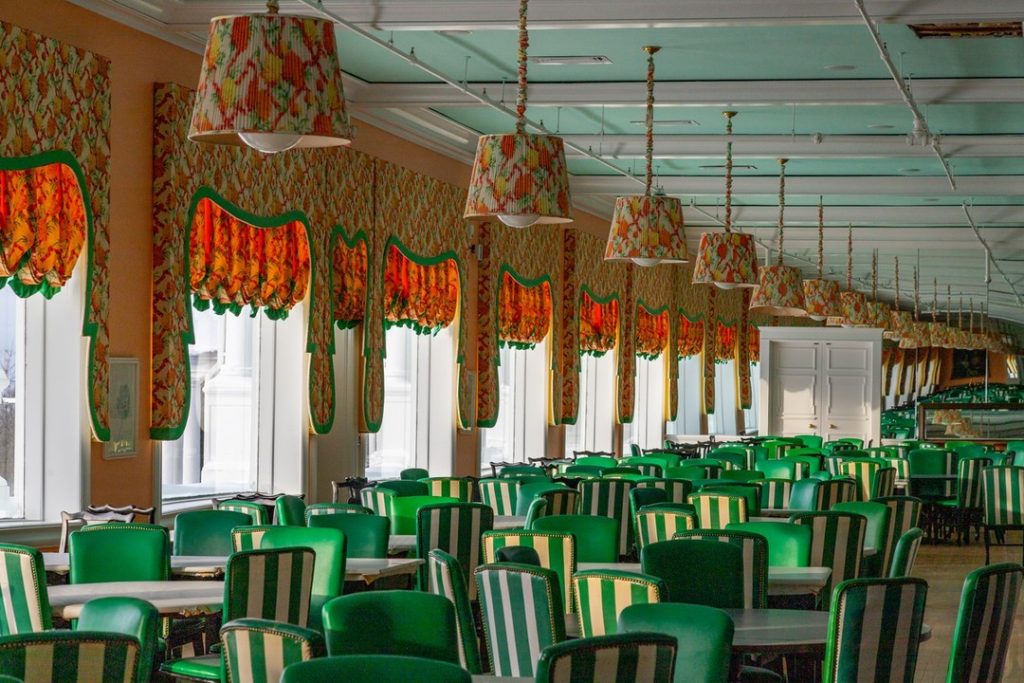 Dining room at Mackinac Island's Grand Hotel with the resort's iconic green and white striped chairs