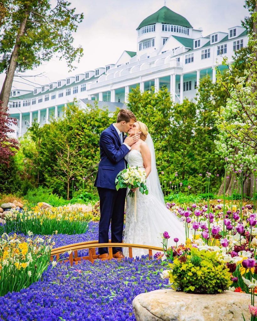 Bride and Groom Kissing on Bridge Outside Grand Hotel on Mackinac Island