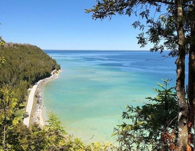 A view of Lake Huron from the edge of a cliff high above on Mackinac Island’s Tranquil Bluff Trail