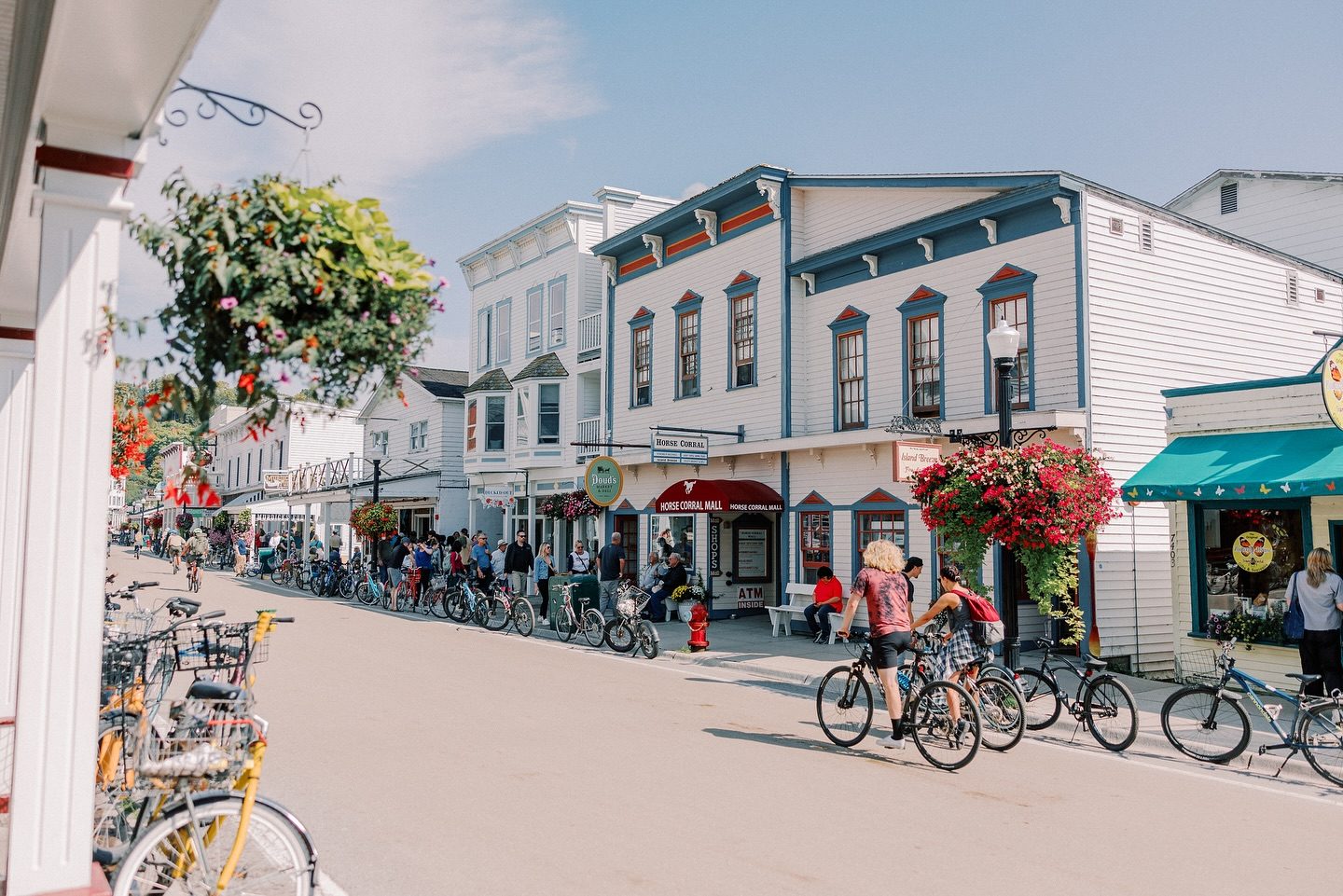 Two boys ride bicycles along Mackinac Island's Main Street on a sunny summer day