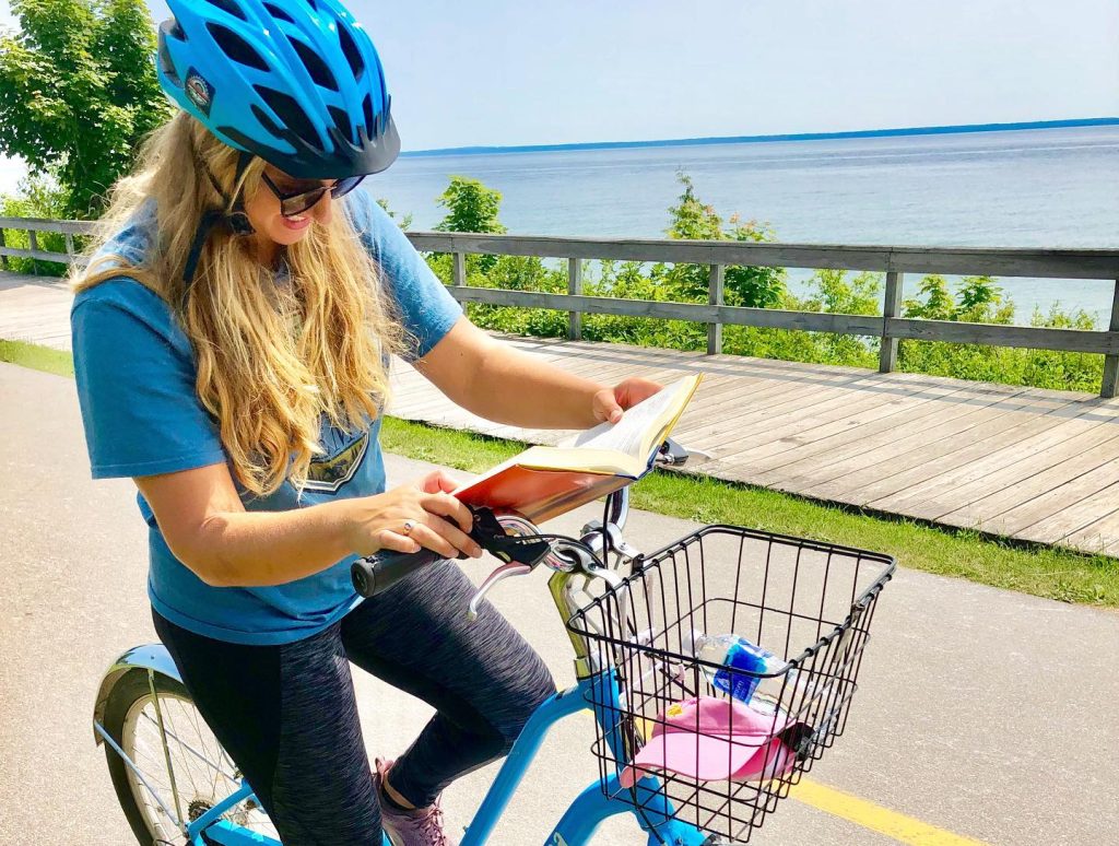 Reading and riding a bicycle on Michigan’s Mackinac Island is possible, if not encouraged.