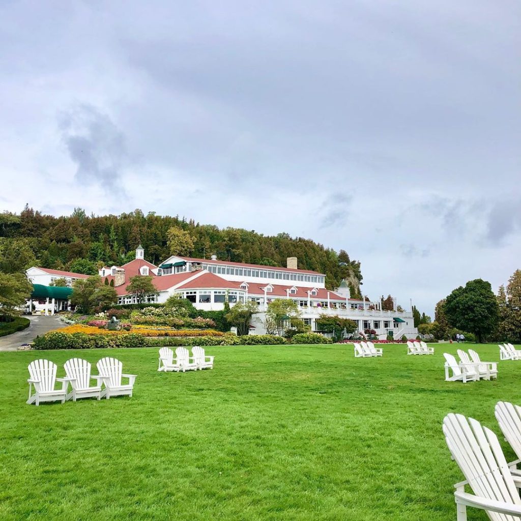 Adirondack chairs dot the great lawn out front of Mackinac Island's Mission Point Resort