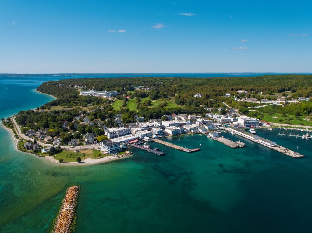 Aerial drone view of downtown Mackinac Island with Grand Hotel, Fort Mackinac and the Jewel golf course