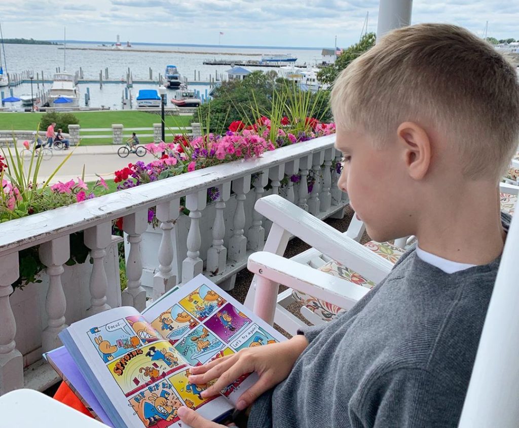 The front porch of Island House Hotel is one of many relaxing places on Michigan’s Mackinac Island to steal away with a book.