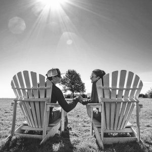 Couple Sitting in Adirondack Chairs – Mackinac Island Tourism Bureau
