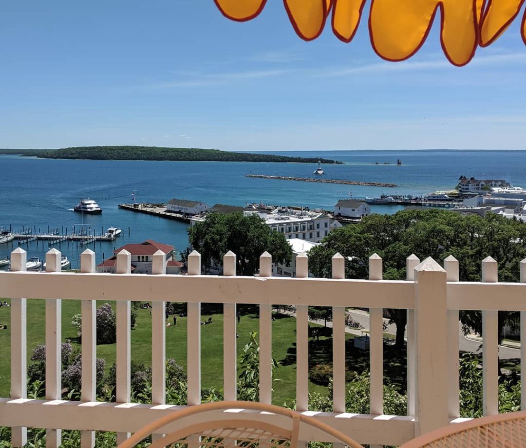 View From Balcony With White Picket Fence at Tea Room Overlooking Waters Surrounding Mackinac Island