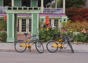 Two bicycles sit parked on the street in front of the Inn at Mackinac on Mackinac Island